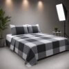 Angle view of a double bed styled with a grey and black check patterned cotton bedspread