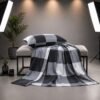 Neatly folded grey and black buffalo check bedspread set with pillowcases stacked on a studio table