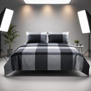 Grey and black plaid bedspread artfully draped over a studio bench with a matching pillow
